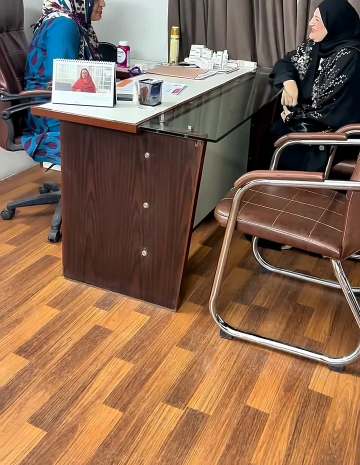 Consultation desk at the North Nazimabad studio, framed certificates on the wall